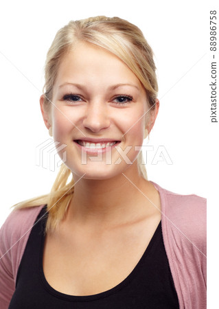 Young and confident. Studio portrait of a beautiful young smiling woman isolated on white. 88986758