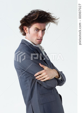 The name is Carlos... Carlos Danger. A young businessman with crazy hair standing on a white background. 88987027