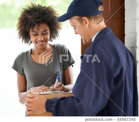 Delivering direct to your door. Shot of a courier making a delivery to a smiling customer. 88987248