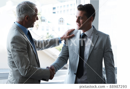 Building business relationships. Two businessmen shaking hands. Building business relationships. Two businessmen shaking hands. 88987293