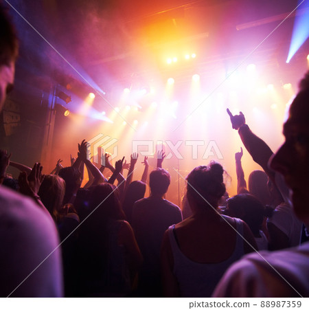 Rocking out. Rear view of a crowd cheering at a concert- This concert was created for the sole purpose of this photo shoot, featuring 300 models and 3 live bands. All people in this shoot are model 88987359