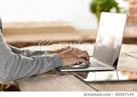 He doesnt have to go far to work.... Shot of a young man working on a laptop at home. 88987544