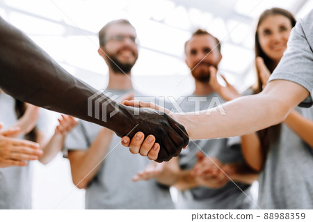 close up. strong handshake of two students of different nationalities close up. strong handshake of two students of different nationalities 88988359