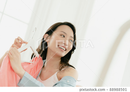 Young woman choosing clothes 88988501