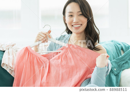 Young woman choosing clothes 88988511