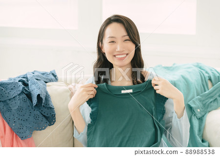 Young woman choosing clothes Young woman choosing clothes 88988538