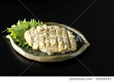 Photographed the namero of a local dish made by hitting a lot of horse mackerel on a black background 88988843