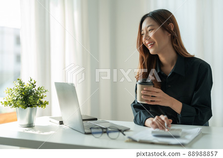 Business accounting concept, Business woman using calculator and computer laptop for budget and loan paper in office. Business accounting concept, Business woman using calculator and computer laptop for budget and loan paper in office. 88988857
