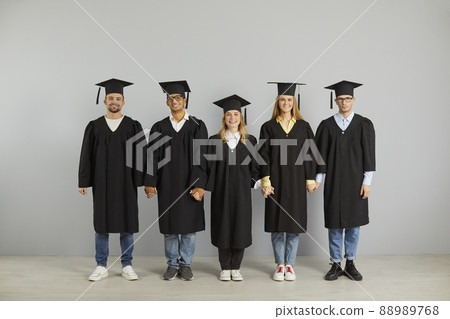 Portrait of diverse college graduates in robes and hats Portrait of diverse college graduates in robes and hats 88989768