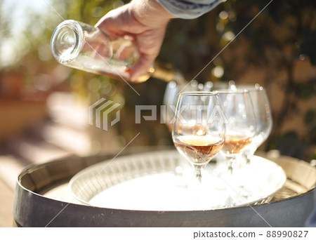 Many glasses and bottle of rose wine in the autumn vineyard 88990827