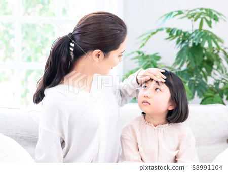 Mom measuring a child's fever 88991104
