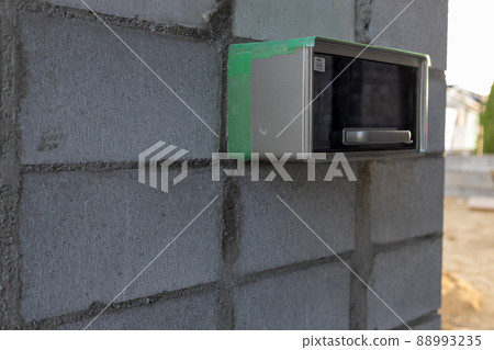 Exterior construction site of a newly built single-family house (mailbox part of the gate) 88993235