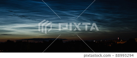 Noctilucent mesospheric clouds in night sky. Rare atmospheric phenomenon over city. Astronomy and meteorology. Banner format. Noctilucent mesospheric clouds in night sky. Rare atmospheric phenomenon over city. Astronomy and meteorology. Banner format. 88993294