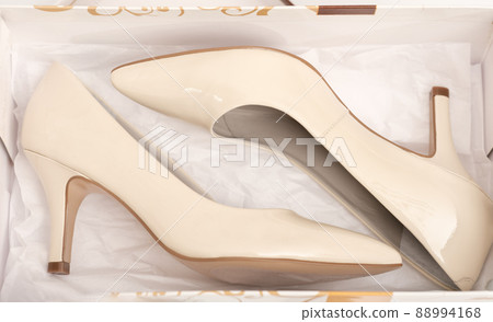 new pair of classic beige heel shoes in a box. shopping, retail and footwear concept. new pair of classic beige heel shoes in a box. shopping, retail and footwear concept. 88994168