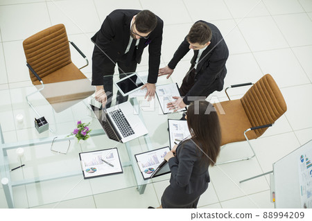 business team working with financial graphs and discusses the profit of the company 88994209