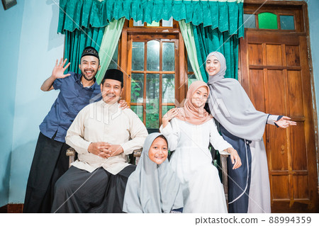 happy asian muslim family at their house on idul fitri 88994359