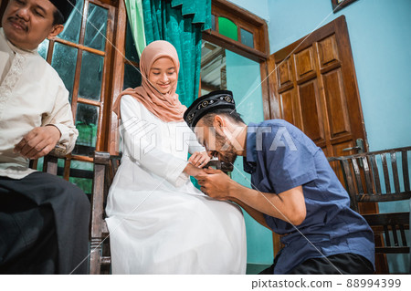 family forgiving each other and shake their hand on idul fitri 88994399