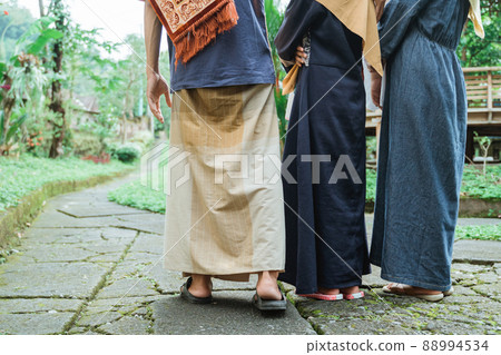 muslim family walking from their house to the mosque for eid mubarak prayer muslim family walking from their house to the mosque for eid mubarak prayer 88994534