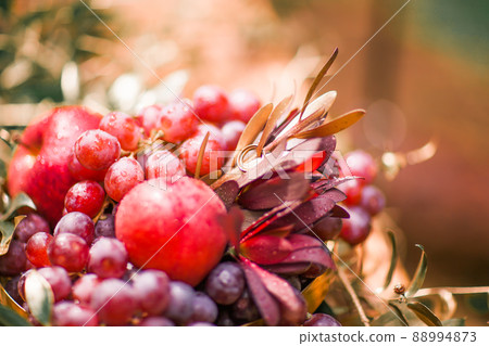beautiful arrangement of fruits,flowers and wedding rings 88994873