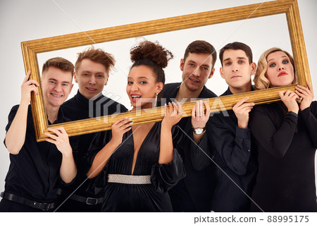studio portrait of Beautiful young diverse group of friends isolated on white background in the frame for a picture, goofy face, good mood studio portrait of Beautiful young diverse group of friends isolated on white background in the frame for a picture, goofy face, good mood 88995175