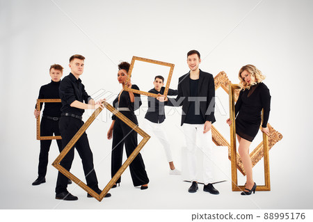 studio portrait of Beautiful young diverse group of friends isolated on white background in the frame for a picture, goofy face, good mood studio portrait of Beautiful young diverse group of friends isolated on white background in the frame for a picture, goofy face, good mood 88995176