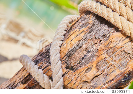 Detail of sailors rope wrapping around wood beam in tropics 88995574