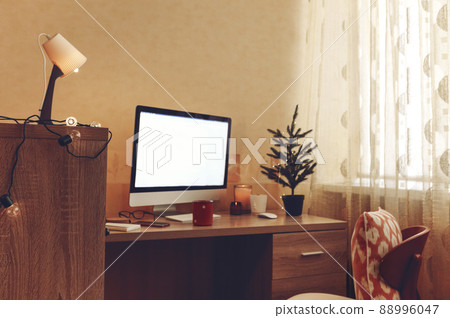 Computer on table in room. Celebration of Christmas online due holiday preperation 88996047