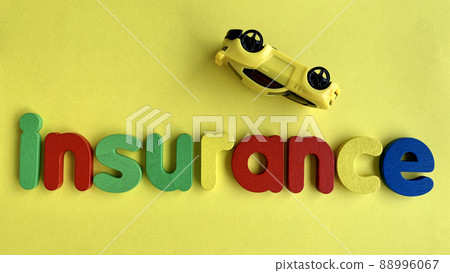 Top view of text - Insurance with car model and yellow background. Top view of text - Insurance with car model and yellow background. 88996067