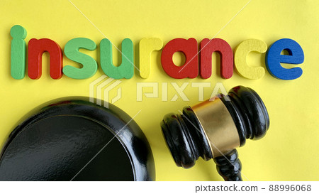 Top view of word Insurance and gavel with yellow paper background. Top view of word Insurance and gavel with yellow paper background. 88996068