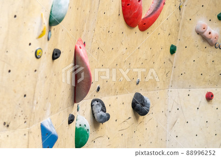 Stone hook on the artificial climbing wall in bouldering gym. Stone hook on the artificial climbing wall in bouldering gym. 88996252
