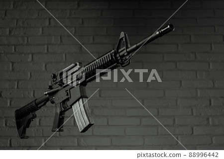 American army rifle M4A1 against a brick wall 88996442