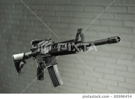 American army rifle M4A1 against a brick wall American army rifle M4A1 against a brick wall 88996454