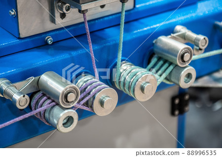 bobbins with rope on the machine of a clothing factory bobbins with rope on the machine of a clothing factory 88996535