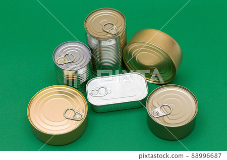 Unopened Tin Cans with Blank Edges on Green Background 88996687