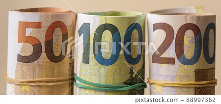 Euro in rolls banner. Fifty, one hundred and two hundred euros are rolled up. Euro in rolls banner. Fifty, one hundred and two hundred euros are rolled up. 88997362