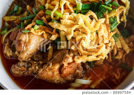 close up Northern Thai Noodle in Chicken coconut milk Curry soup ( Khoa Soi Kai) 88997584