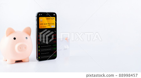E banking concept. Mobile phone with internet online bank app. Pig bank with credit card on white background. Online wallet save money. 88998457