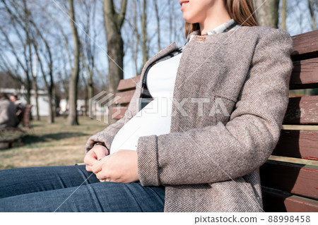 Pregnancy walking woman. Baby belly. Pregnant walk nature. Happy maternity mother in summer park. Active pregnancy. Pregnancy walking woman. Baby belly. Pregnant walk nature. Happy maternity mother in summer park. Active pregnancy. 88998458