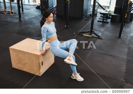 Fitness girl exercising on a wooden box for crossfit 88998997
