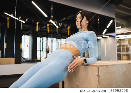 Fitness girl exercising on a wooden box for crossfit 88998998