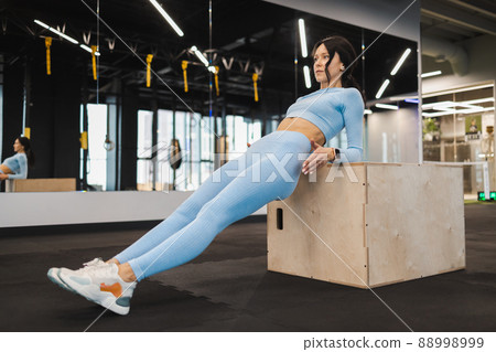 Fitness girl exercising on a wooden box for crossfit 88998999