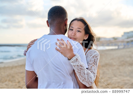 Young loving couple hugging on the beach Young loving couple hugging on the beach 88999747