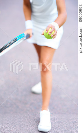 Get ready for the serve. Cropped view of a young female tennis player getting ready to serve the ball. Get ready for the serve. Cropped view of a young female tennis player getting ready to serve the ball. 89000998