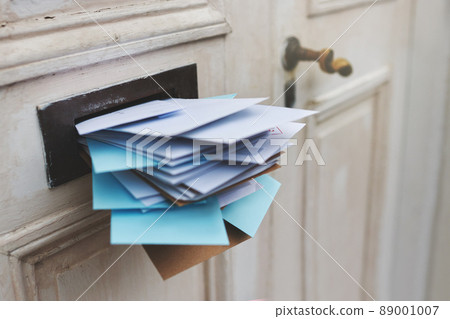 Jam-packed with the post. Cropped shot of letters in a letter box. 89001007