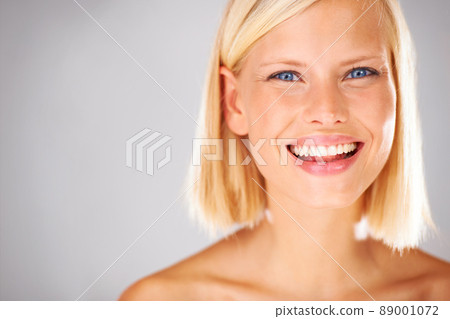 She will bring all the attention here - Copyspace. Portrait of a pretty young woman with a large grin and copyspace beside her. She will bring all the attention here - Copyspace. Portrait of a pretty young woman with a large grin and copyspace beside her. 89001072
