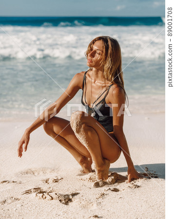 Beautiful young woman enjoy at ocean beach 89001708