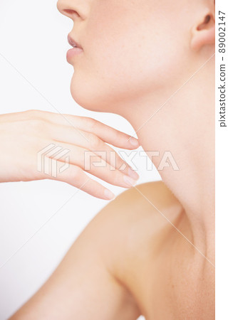 What beautiful skin. Cropped view of a young woman touching her shoulder. 89002147