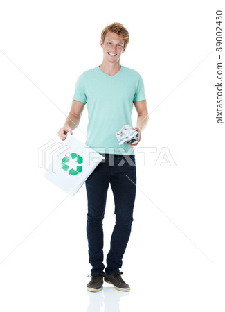 Getting in the right habit. A handsome young red-headed man ready to throw away a piece of paper in the recycling bin - portrait. Getting in the right habit. A handsome young red-headed man ready to throw away a piece of paper in the recycling bin - portrait. 89002430