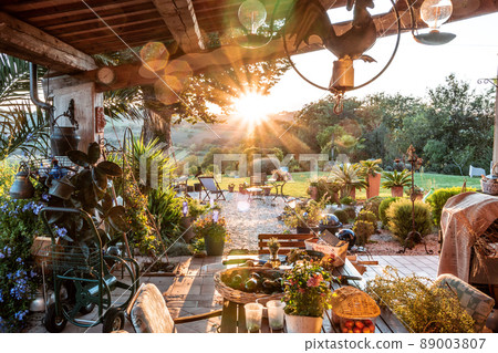 beautiful italian terrace with view on a magical garden during sunset beautiful italian terrace with view on a magical garden during sunset 89003807
