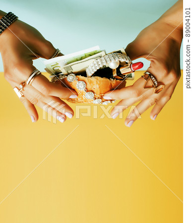 woman hands holding hamburger with money, jewelry, cosmetic 89004101